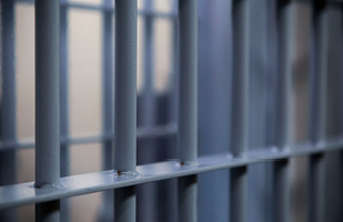 Close-up image of jail cell bars.