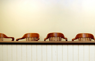 Image showing a row of empty wooden chairs.