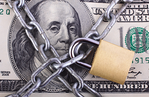 Image showing a one hundred dollar bill with a chain and padlock on it.