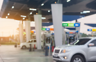 Image showing cars parked next to gas pumps at a gas station.