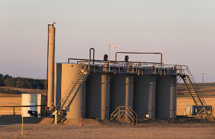 Image of five large steel tanks side-by-side.