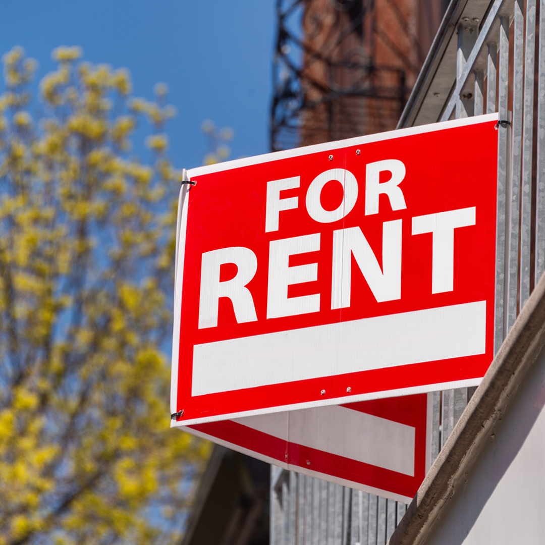 A red and white 'For Rent' sign.