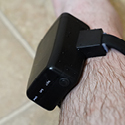 A black ankle monitor attached to a leg.