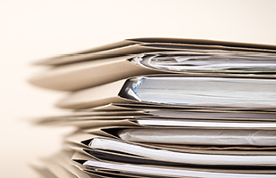 a stack of papers in multiple folders