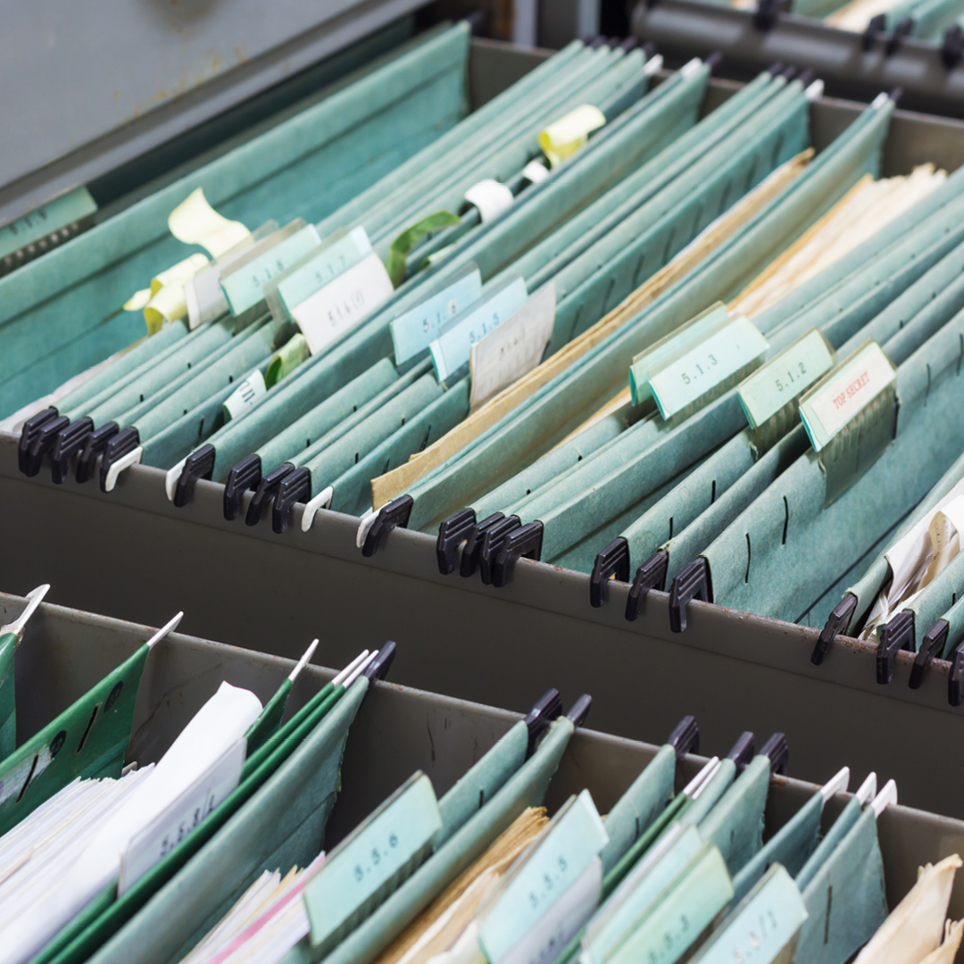 Hanging file folders in a filing cabinet drawer.