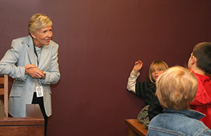 Educator-guide Jodi Hawk teaches students in the Mock Trial Room of the Visitor Education Center at the Thomas J. Moyer Ohio Judicial Center, home of the Ohio Supreme Court.