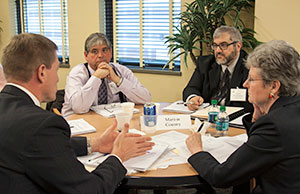 Image of four men engaged in a discussion