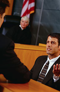 Image of an attorney questioning someone in court