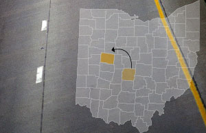 Image of a county map of ohio, with Franklin and Logan counties highlighted, superimposed over a highway Image of a county map of ohio, with Franklin and Logan counties highlighted, superimposed over a highway