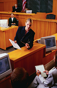 Image of an attorney arguing a case in a courtroom Image of an attorney arguing a case in a courtroom