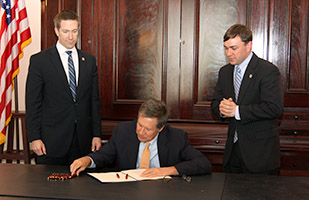 Image of Ohio Governor John Kasich, and state representatives Jim Butler and Michael Stinziano Image of Ohio Governor John Kasich, and state representatives Jim Butler and Michael Stinziano
