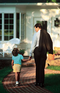 Image of a man in a suit holding a little girls hand as they walk together Image of a man in a suit holding a little girls hand as they walk together