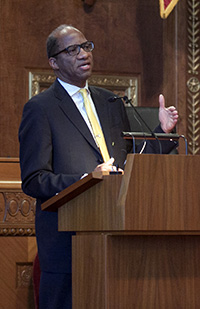 Image of Wil Haygood speaking at a podium in the courtroom of the Thomas J. Moyer Ohio Judicial Center