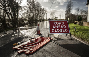Image of a flooded roadway behind a 'Road Closed Ahead' warning sign (Thinkstock) Image of a flooded roadway behind a 'Road Closed Ahead' warning sign (Thinkstock)