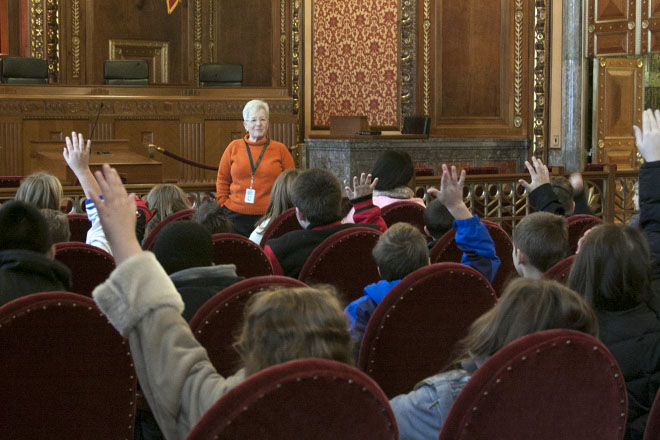 Image of students in the courtroom with a tour guide. Image of students in the courtroom with a tour guide.