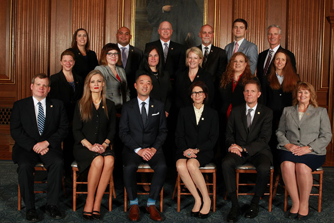 Image of three rows of men and women posing for a group portrait Image of three rows of men and women posing for a group portrait