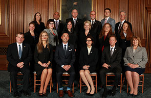 Image of three rows of men and women posing for a group portrait Image of three rows of men and women posing for a group portrait