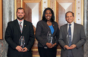 Image of three Ohio Supreme Court employees holding their Professional Excellence awards Image of three Ohio Supreme Court employees holding their Professional Excellence awards