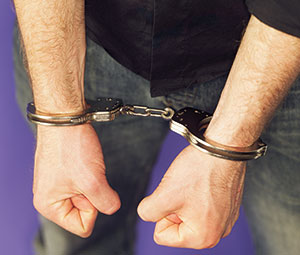Image of a man's hands in handcuffs