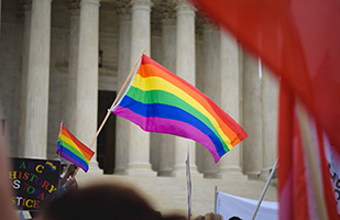 Image of the rainbow flag associated with the LGBT community on the steps of the U.S. Supreme Court Image of the rainbow flag associated with the LGBT community on the steps of the U.S. Supreme Court