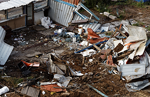 Image of a destroyed home surrounded by debris after a natural disaster (Thinkstock)