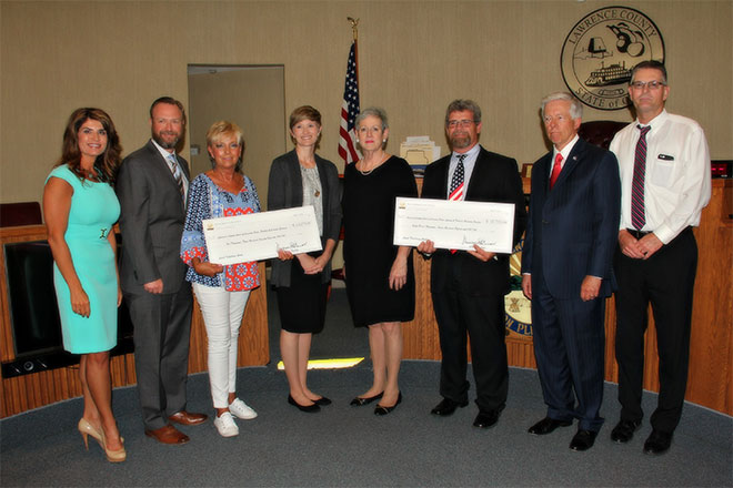 Image of Ohio Supreme Court Chief Justice Maureen O'Connor presenting checks to various members of Lawrence County Courts