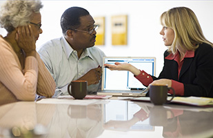 Image of an elderly couple speaking with an attorney