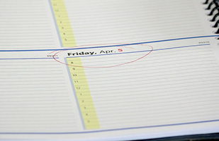 Image of a day planner opened to Friday, April 5 with the date circled in red