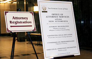 Image of a sign that reads: 'Attorney Registration' next to another sign with information for newly admitted attorneys