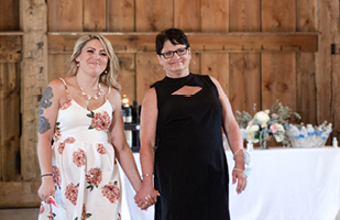 Image of two woman holding hands and smiling