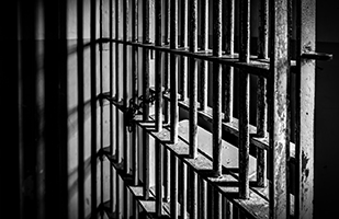 Image of prison bars (iStock/DanHenson1)