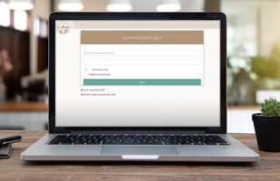 Image of a laptop computer showing the Supreme Court Attorney Portal on the screen.