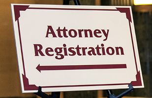 Image of a sign resting on a stanchion. The sign says:'Attorney Registration.'