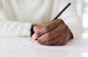 Image showing a man's hand holding a pencil.