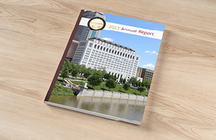 Image showing a booklet with a picture of the Thomas J. Moyer Ohio Judicial Center on the cover sitting on a wooden surface.