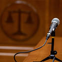 A courtroom table with a microphone