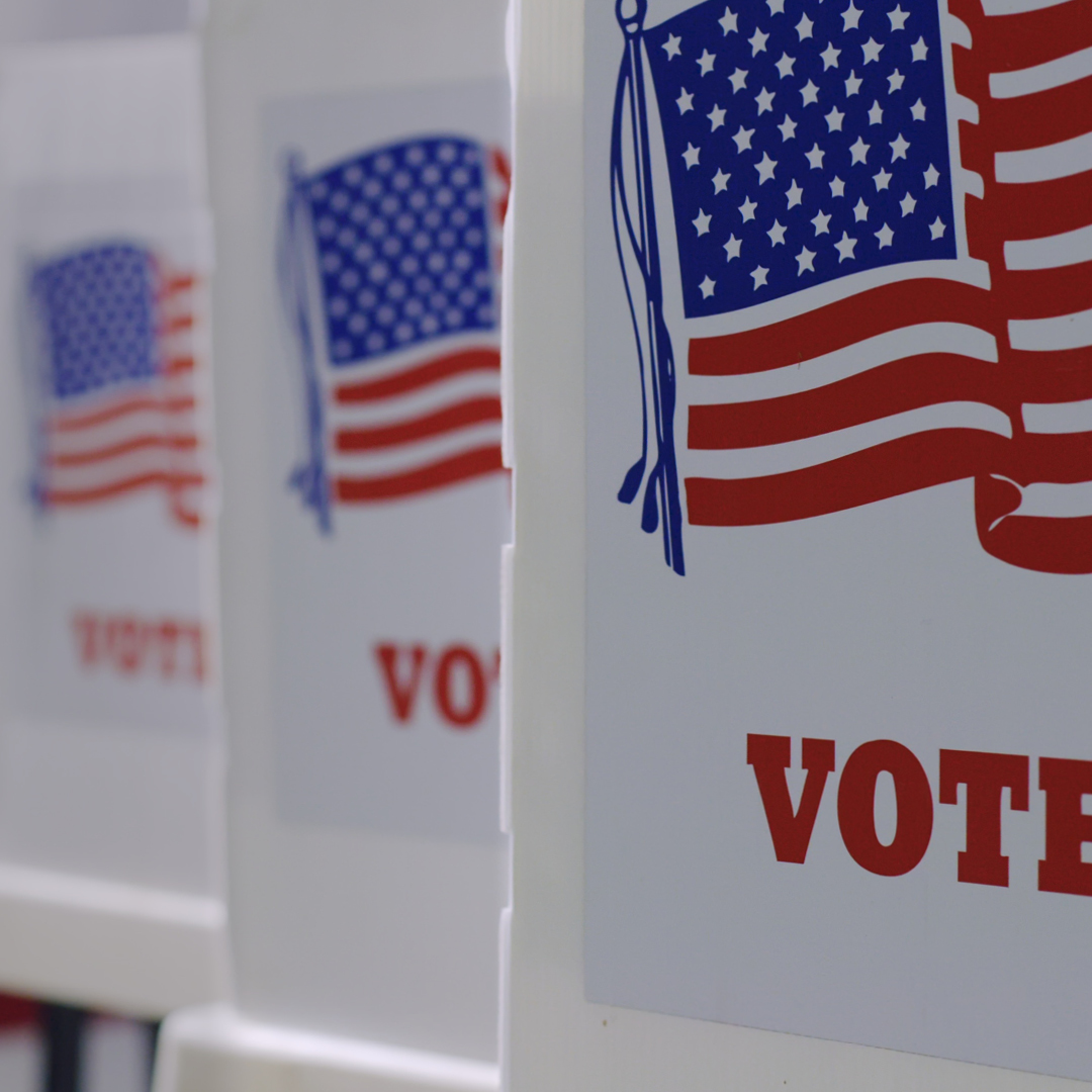 American flags with the word 'Vote' underneath.