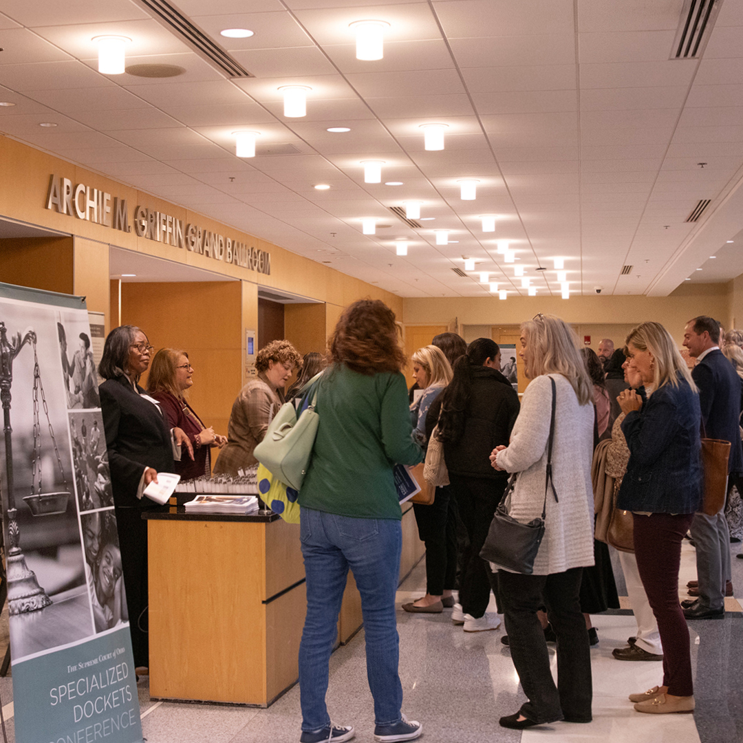 A group of men and women checking in at a registration counter.