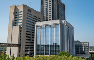 Three multi-story buildings in a downtown area.