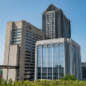 Three multi-story buildings in a downtown area.