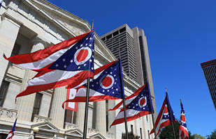 Ohio flags flying outside of the Ohio Statehouse