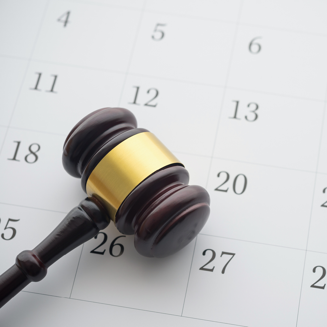 A gavel sitting on a calendar