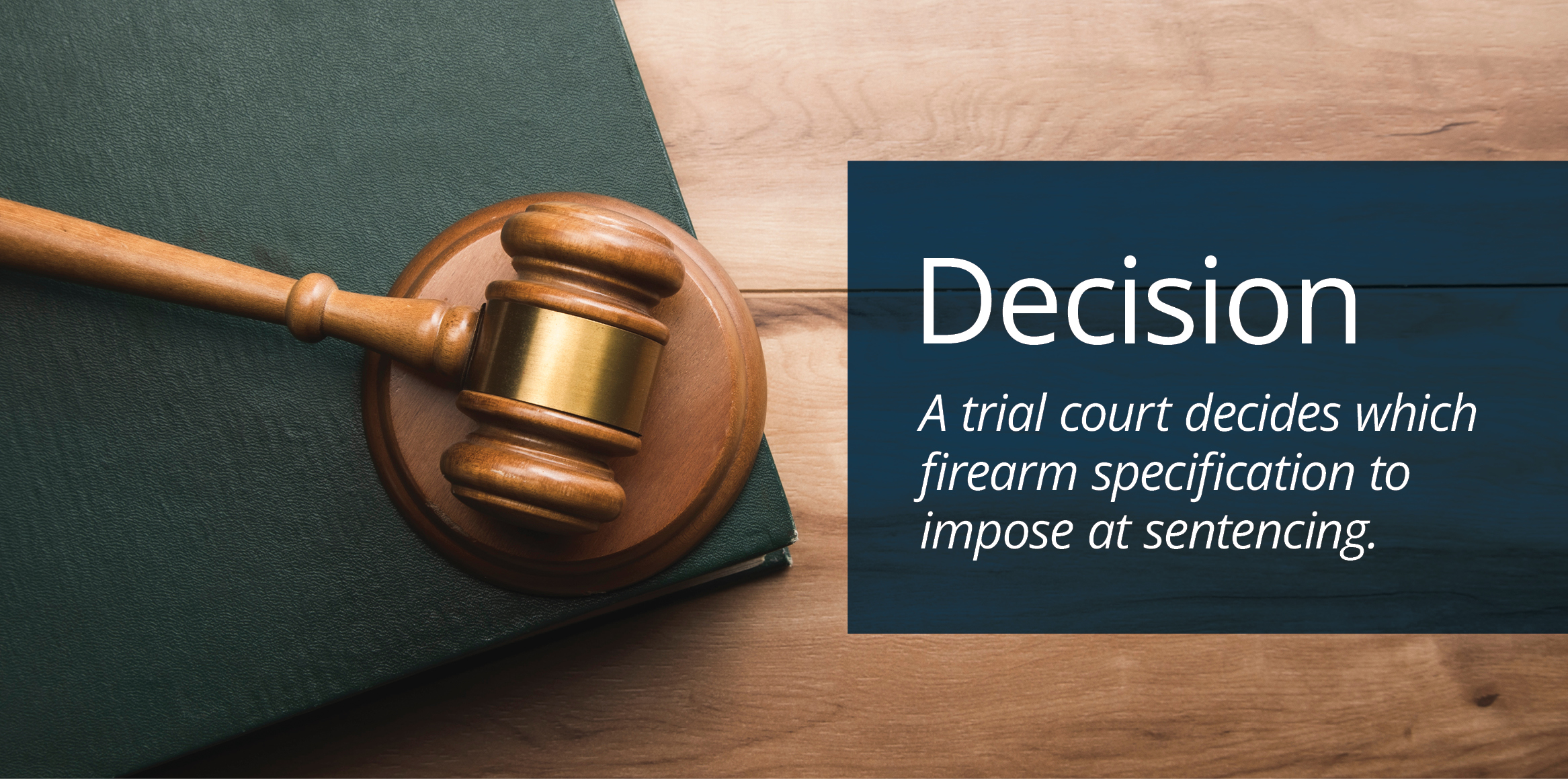 Wooden judge’s gavel resting on a sound block atop a closed law book on a wooden surface.