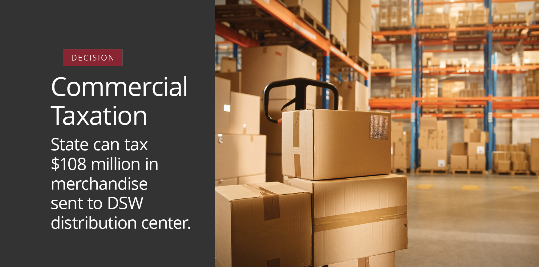 Cardboard boxes stacked on metal shelving in a large warehouse.