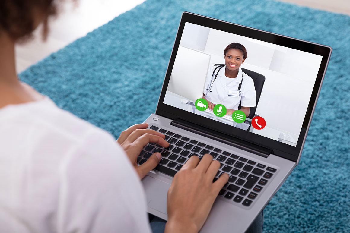 Image of a woman engaged in a videoconference on a laptop