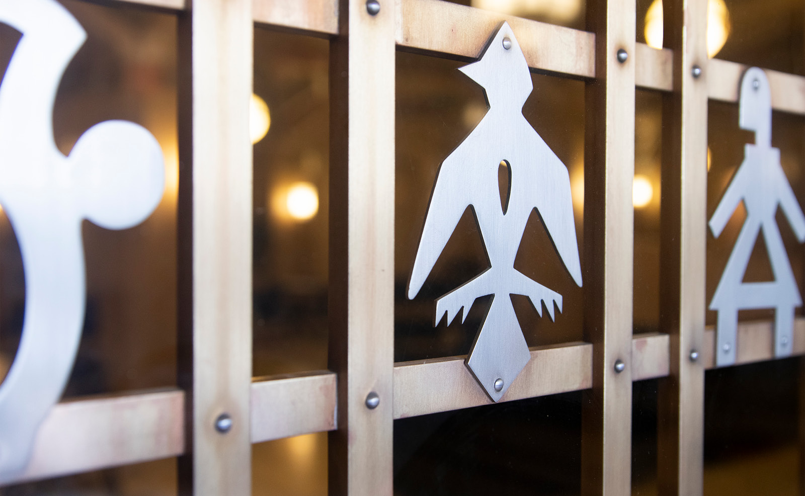 Image of carved metal symbols on a bronze door