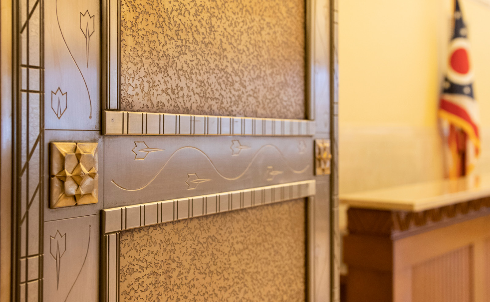 Image of a closeup of the etchings found in the nickel of the Civic Center Lobby doors