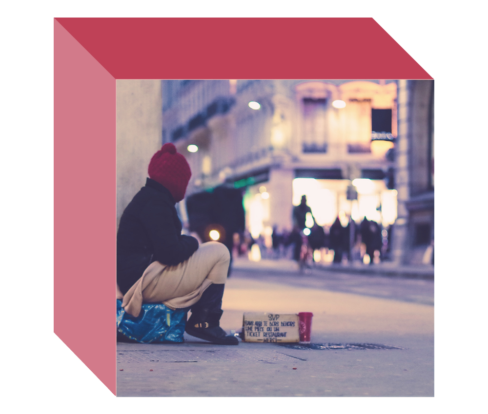 Image of a homeless person sitting on a busy downtown street on the front-facing side of a multi-dimensional cube
