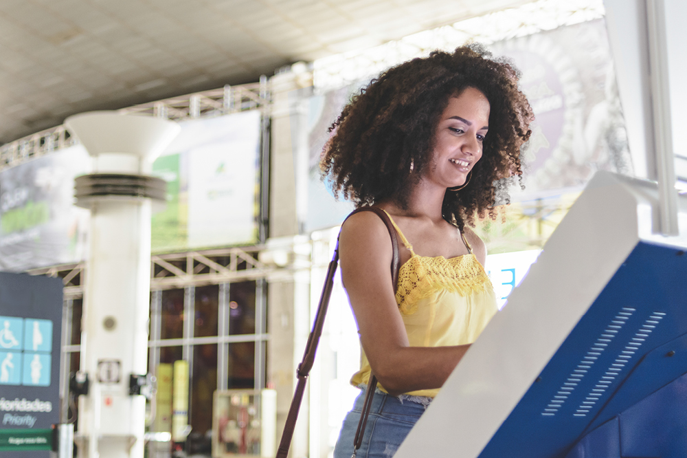 Image of a woman using a computer kiosk