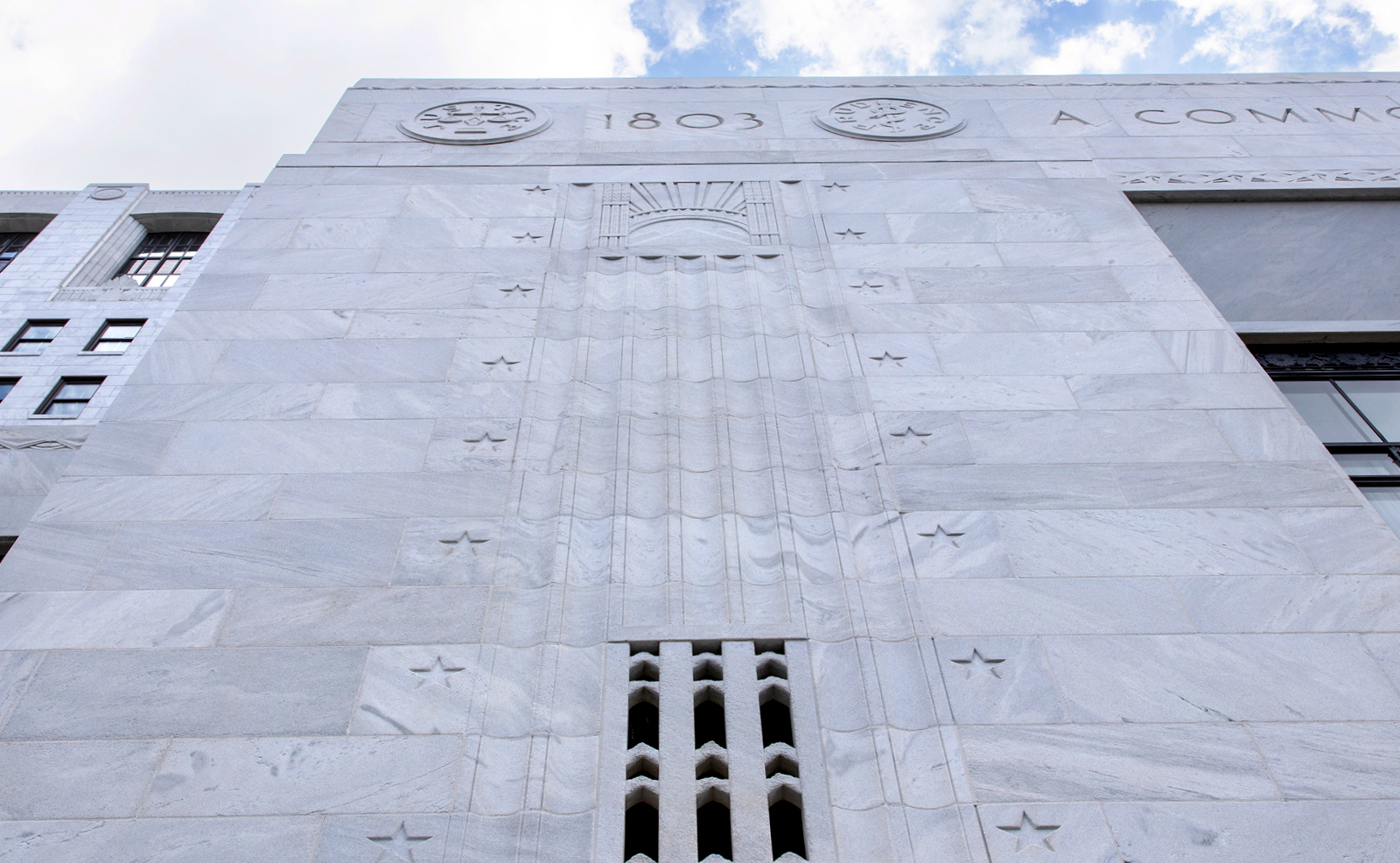 Image of vertical fluted, column-looking sections of the exterior of the Thomas J. Moyer Ohio Judical Center engraved with stars and the year 1803